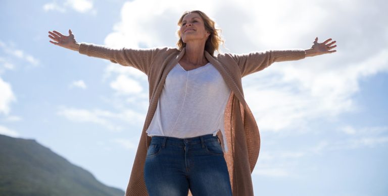 mature-woman-with-arms-outstretched-standing